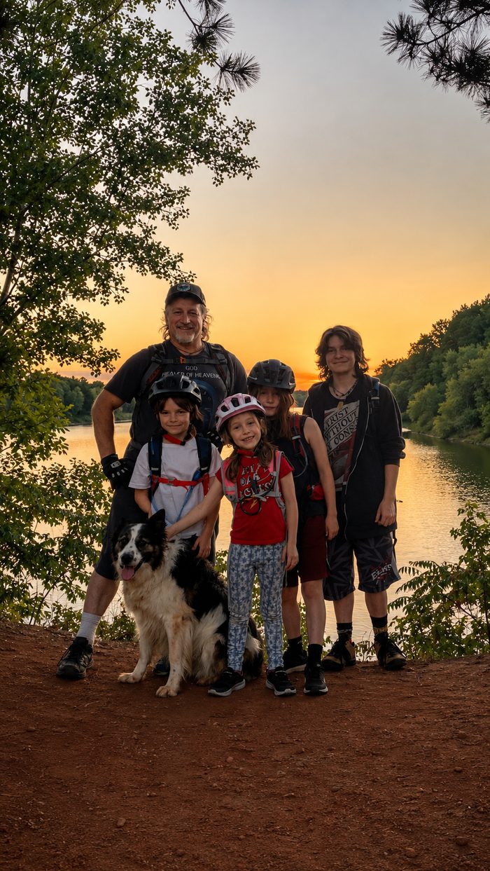 Jimmy Davidson with his four kids and their dog at sunset on the Cuyuna Lakes trails